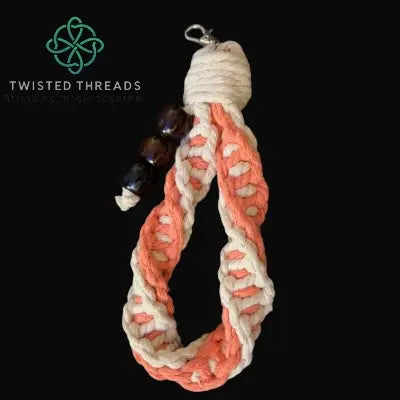 chunky coral double spiral keychain with 3 wooden beads on black background
