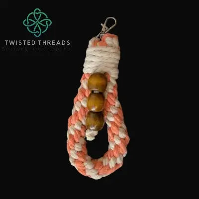 chunky keychain with coral/beige rope and brown beads on a black background