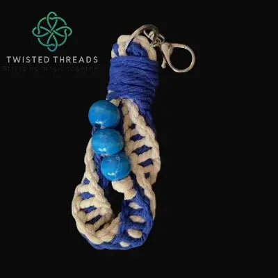 chunky navy double spiral keychain with 3 wooden beads on black background